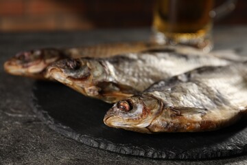 Dried roach fish on grey table, closeup
