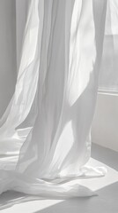 Sheer white curtains gently flowing in sunlight near window.