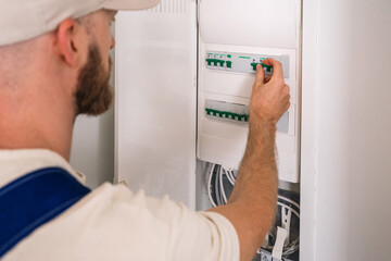 Expert electrician performing maintenance in a residential electrical panel