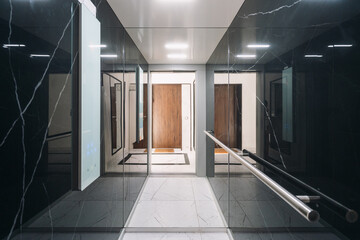 Modern elevator interior in a residential building with sleek design features © brizmaker