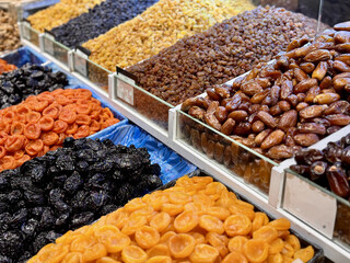 A Beautiful and Colorful Assortment of Various Dried Fruits and Nut Varieties on Display. A vibrant display shows various dried fruits and nuts, highlighting their rich colors and unique textures