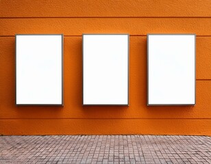 Three mock up posters on orange building wall
