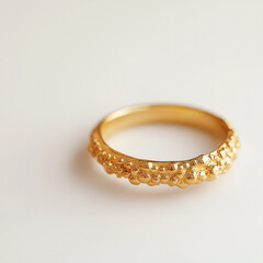 Sophisticated gold ring with intricate detailing elegantly visually displayed against a subtle, soft-focus luxurious backdrop