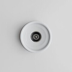 A minimalist sink drain with a simple design, placed in a sleek setting, epitomizes modern functionality and style.