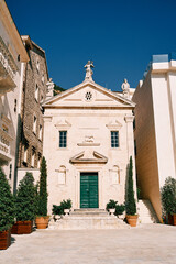 Fototapeta premium Facade of the ancient church of St. Mark with sculptures on the roof. Perast, Montenegro