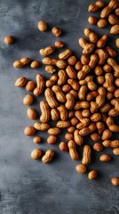 Roasted Peanuts Scattered on Dark Surface, Top View