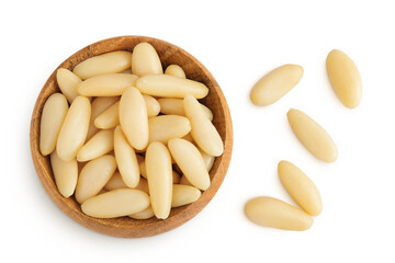 Shelled European pine nuts in wooden bowl isolated on white background with full depth of field. Top view. Flat lay