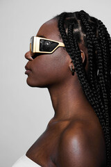 Stylish black model with braided hair wearing oversized sunglasses, showcasing a modern and urban...