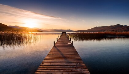 Fototapeta premium lake at sunset long wooden pier