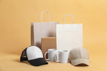 Different blank items for branding on beige background. Mockup for design