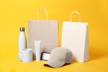 Different blank items for branding on orange background. Mockup for design