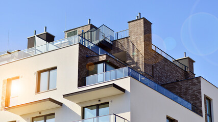 Apartment building with  symmetrical modern architecture in the city. Modern apartment building on a sunny day. Facade of a modern apartment building. Bottom view. 
