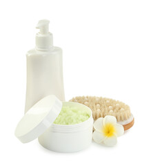 Different body care products and plumeria flower isolated on white