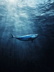 Naklejka premium Tuna Swimming Gracefully Underwater with Sun Rays Through Dark Ocean Depth