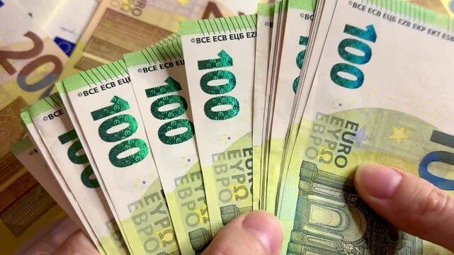 Counting euro banknotes. Female hands count 100 euros cash. Investments, family budget and savings concept	 - Powered by Adobe