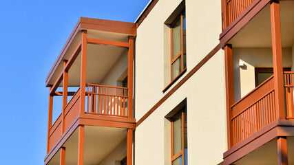 New apartment building. Residential area with modern apartment building. in sunny day. Fragments of the wooden facade.
