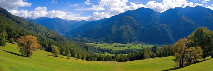Fototapeta premium Scenic mountains rise above a valley adorned with several trees in the foreground.