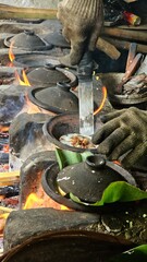 The seller lifted the cooked serabi and ready to eat.Traditional process of cooking 