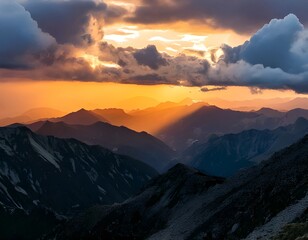 Fototapeta premium Dramatic Mountain Peaks Landscape at Golden Hour with Clouds and Sunlight