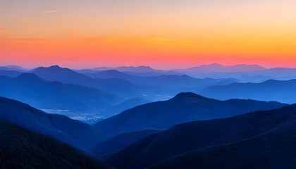 Obraz premium Mountain Range Landscape at Colorful Sunset with Rolling Blue Hills