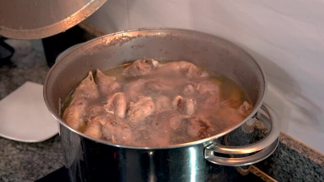 Chicken broth simmering in a pot on the stove