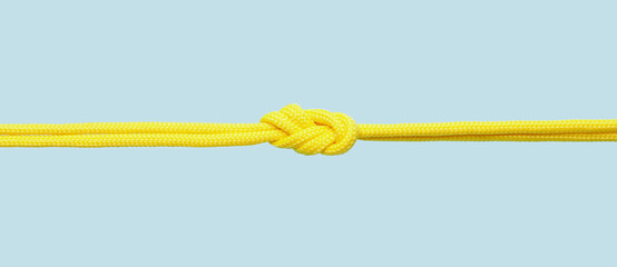 Rope with knot on color background