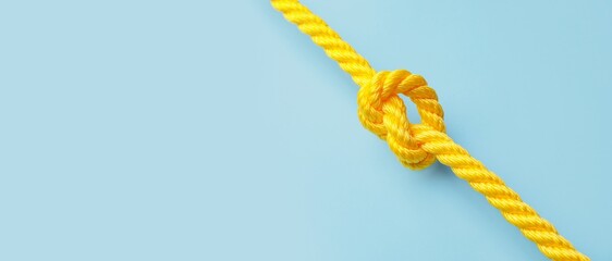 Rope with knot on blue background. Concept of connection