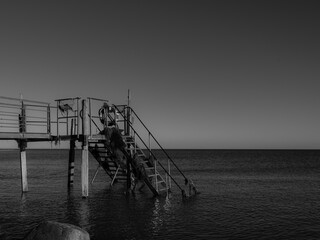 Pier on coast at winter, covered with seagrass 