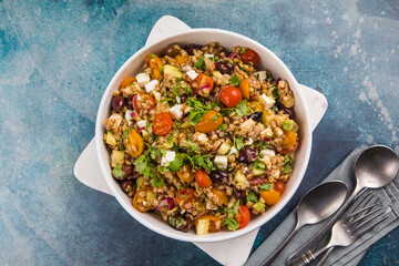 Farro salad. Cooked whole grain cereal spelt as salad with vegetables and feta cheese