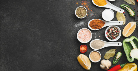 Different spices and vegetables on dark background
