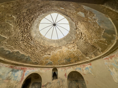 Pompeii, Campania, Italy - July 6, 2024: Ancient Roman City ruins on Via Dell' Abbondanza. Terme Stabiane building, the Stabian Baths. The open dome above the community bath - Powered by Adobe