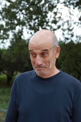 Bald Senior Man Smiles Saying Yes With His Face Outdoors In The Park