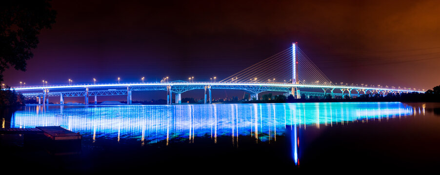 Champlain Bridge Illuminated at Night with Reflections in the River