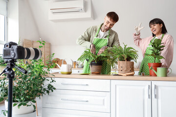 Couple of bloggers with plants recording video at home
