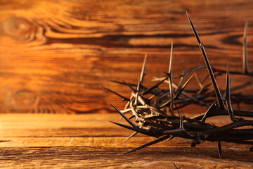 Crown of thorns on wooden background, closeup. Good Friday concept