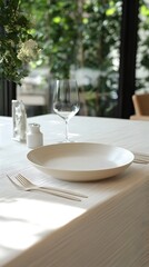 Fototapeta premium Elegant Table Setting with White Plate and Glass