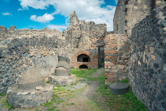 Ancient Ruins of a Bakery in Pompeii, Italy Under a Bright Blue Sky