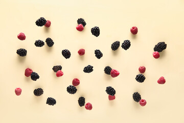 Blackberry and raspberry flying on beige background