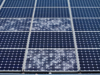 AERIAL, CLOSE UP: Set of solar panels severely damaged by a hailstorm. Spiderweb patterns spread...
