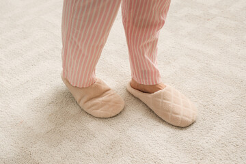Woman in slippers walking on soft carpet. New beginning concept