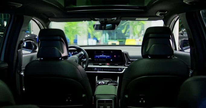 Electric car interior details adjustments. Inside car interior with front seats, driver and passenger, textile, multimedia, windows, console, gear shift, electric buttons, digital speedometer.
