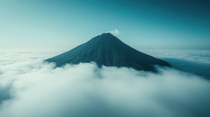 Fototapeta premium Majestic volcano peak above a sea of clouds