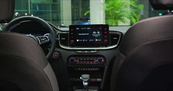 Electric car interior details adjustments. Inside car interior with front seats, driver and passenger, textile, multimedia, windows, console, gear shift, electric buttons, digital speedometer.