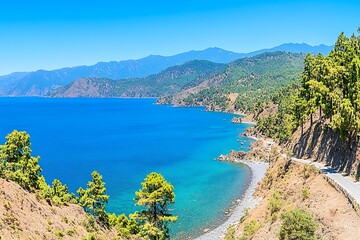 Fototapeta premium Serene Coastal Landscape with Turquoise Water and Mountains