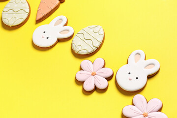 Composition with different Easter cookies on yellow background