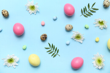 Composition with flowers and Easter eggs on blue background