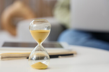Hourglass on table in room, closeup