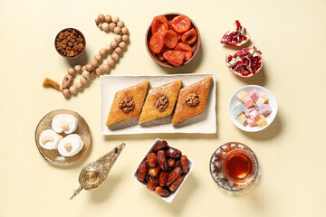 Sweet baklava, dried apricots, dates and Turkish delight on beige background. Ramadan celebration