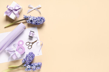 Figure 8 with lilac flowers, gift boxes and wrapping paper on beige background. International Women's Day