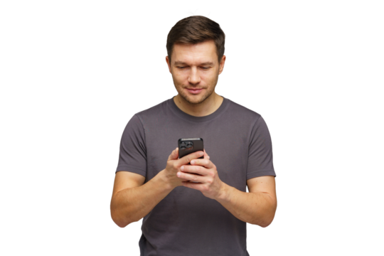 Young man using smartphone while standing against a white background in a casual setting